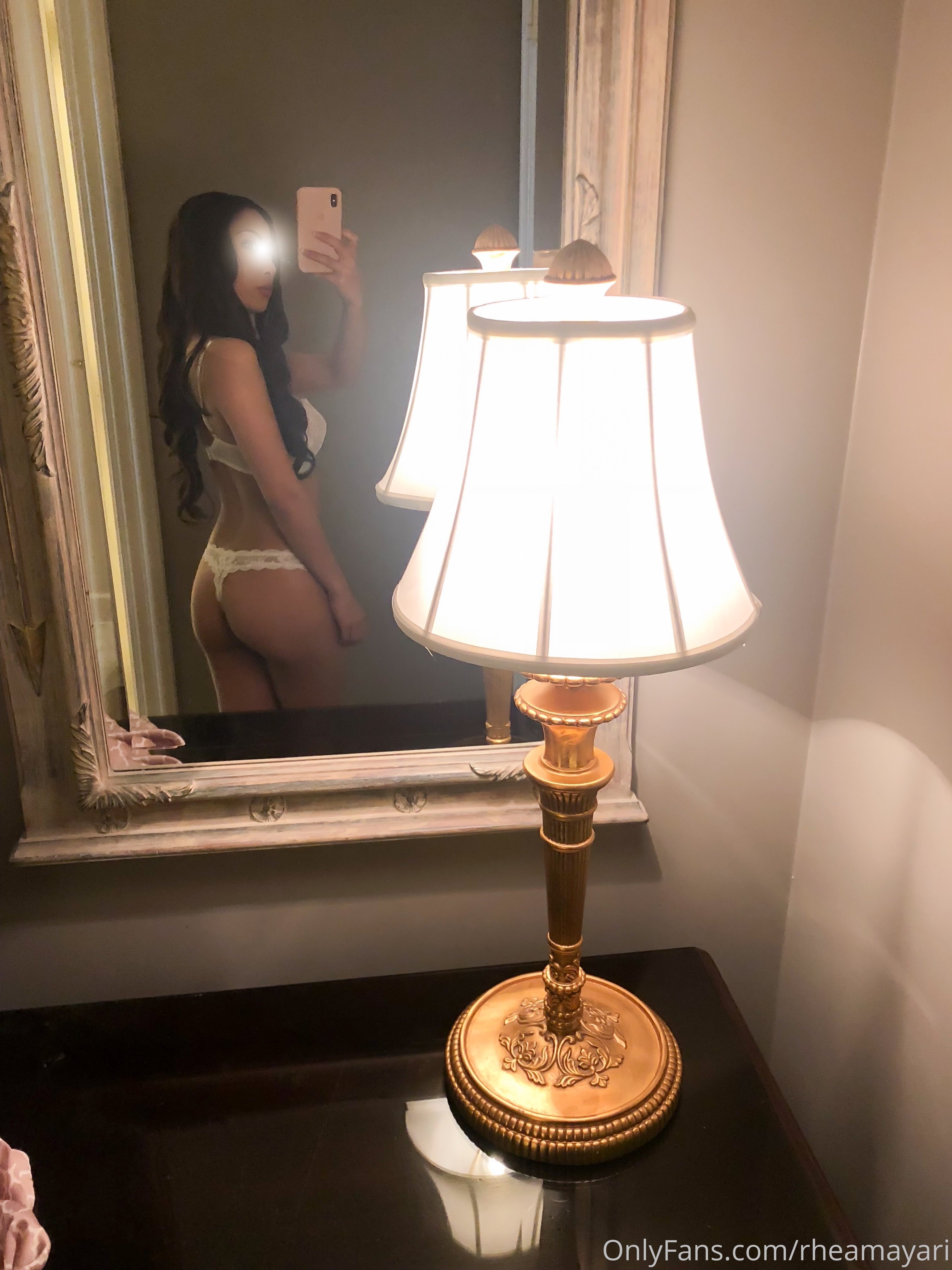 Vanessa Rallonza, a 34-year-old petite Filipino-American woman with dark brown hair, poses seductively in her lingerie, capturing her flawless reflection in the mirror. The nude photo showcases her alluring curves and confident demeanor, leaving little to the imagination.